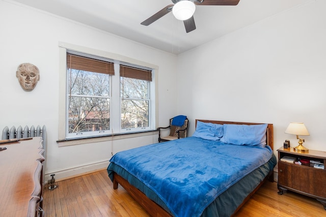 bedroom with light hardwood / wood-style floors and ceiling fan