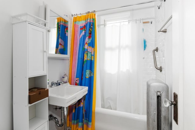 bathroom featuring sink and shower / tub combo with curtain