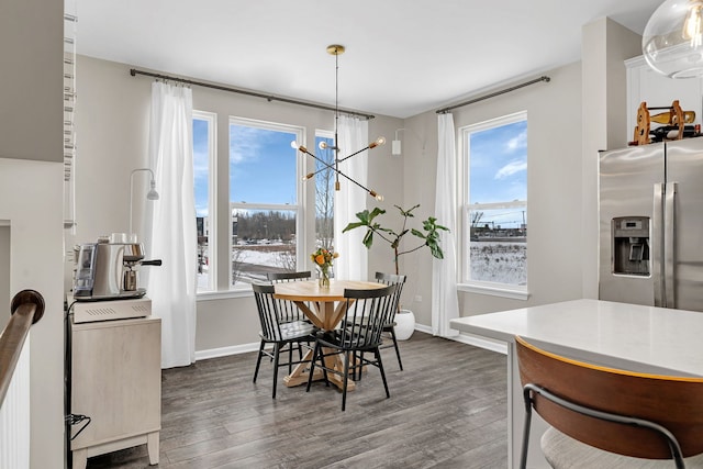 dining room with a wealth of natural light, dark wood-type flooring, and baseboards