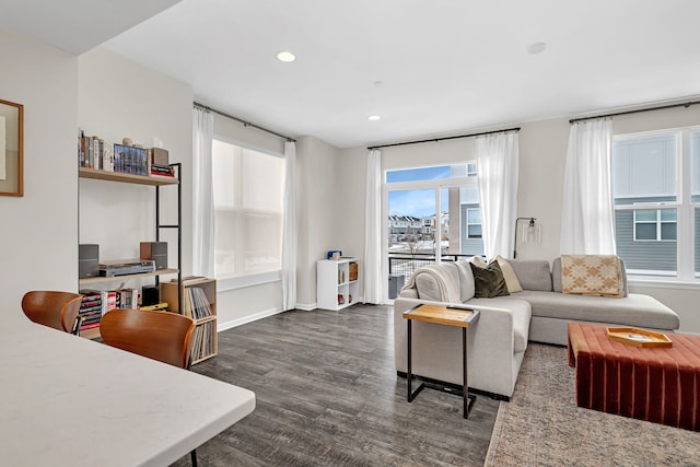 living area featuring recessed lighting, baseboards, and dark wood-style flooring