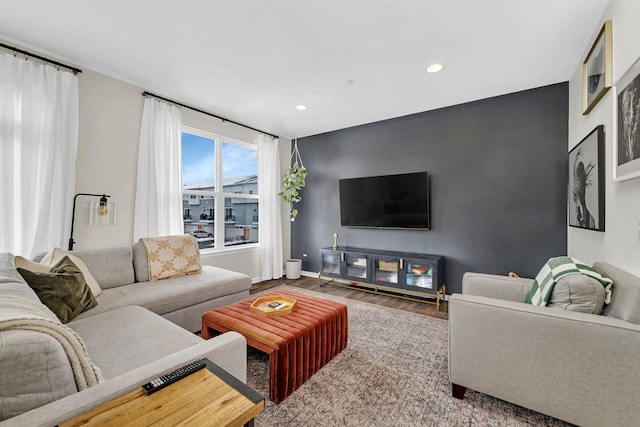 living area with recessed lighting, wood finished floors, and baseboards