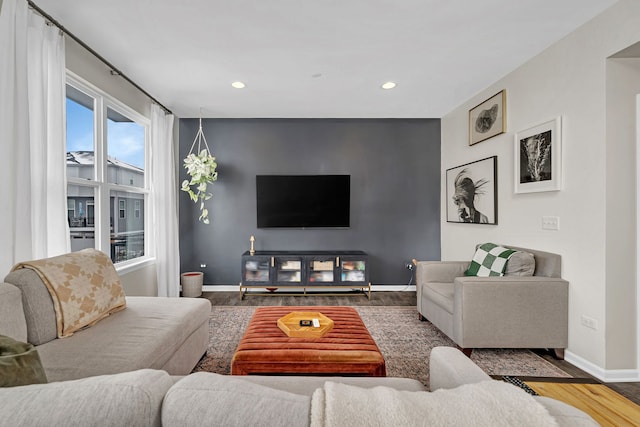 living area featuring recessed lighting, wood finished floors, and baseboards