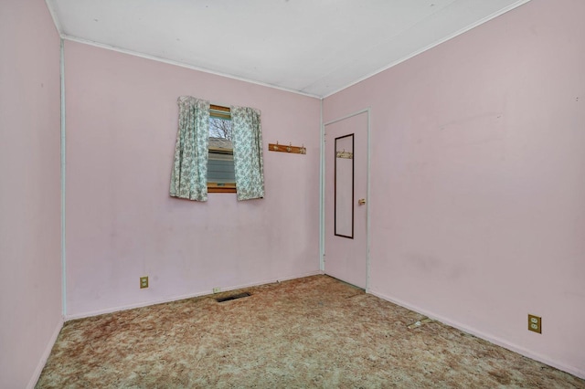 carpeted spare room with crown molding