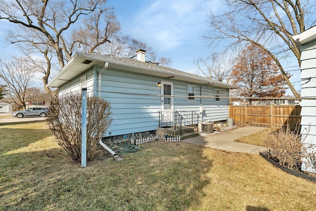 back of house with a lawn