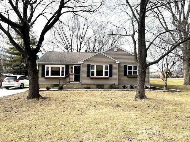 ranch-style home with a front lawn