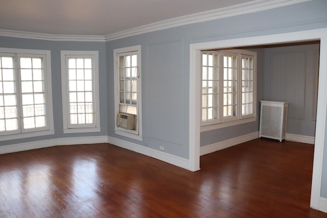 spare room with cooling unit, a wealth of natural light, ornamental molding, and dark hardwood / wood-style floors