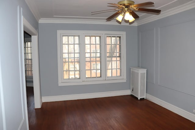 spare room featuring dark hardwood / wood-style flooring, crown molding, and ceiling fan