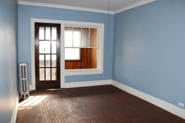 unfurnished room featuring ornamental molding, radiator heating unit, and dark hardwood / wood-style flooring