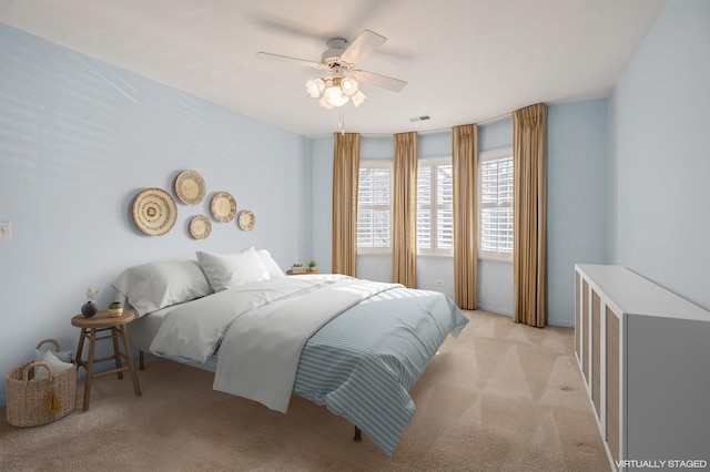 carpeted bedroom with ceiling fan