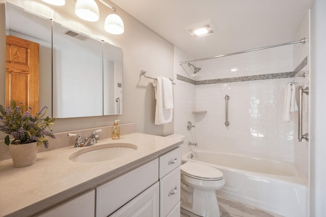 full bathroom featuring vanity, toilet, and tiled shower / bath