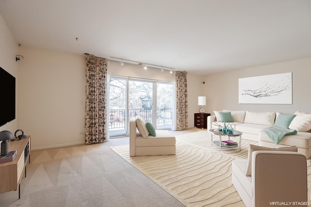 living room featuring light carpet and rail lighting