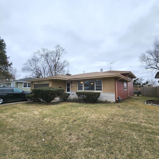 single story home featuring a garage and a front yard