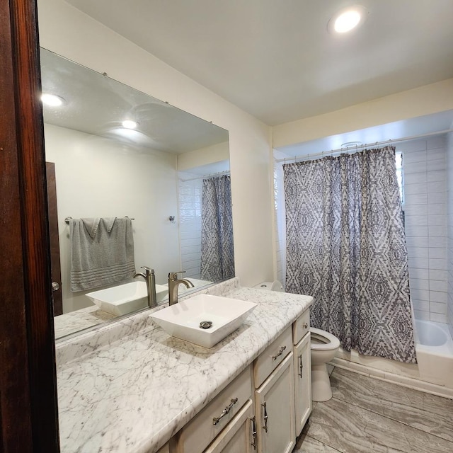 full bathroom with vanity, shower / bath combination with curtain, and toilet