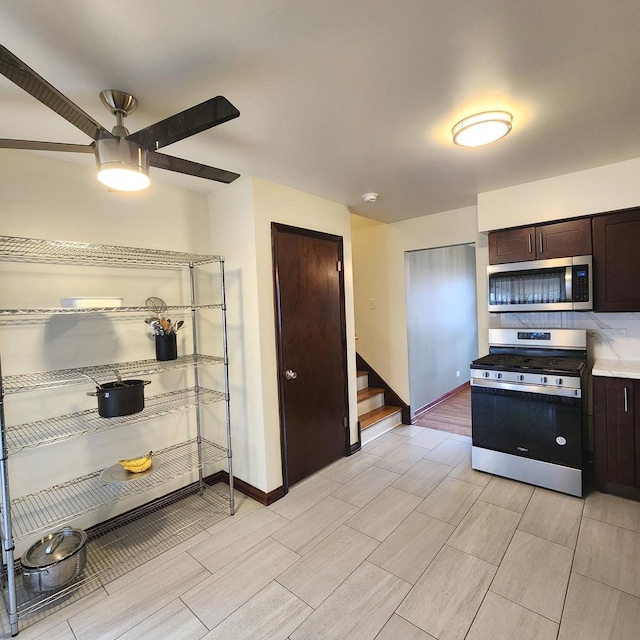 kitchen featuring appliances with stainless steel finishes, dark brown cabinets, and ceiling fan