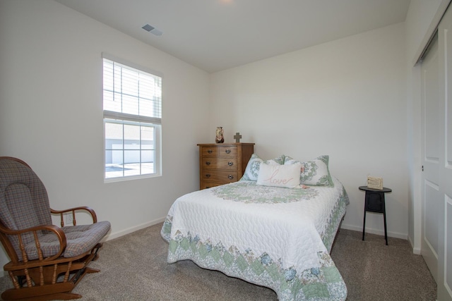 carpeted bedroom with a closet