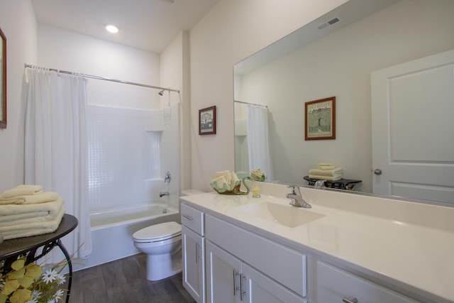 full bathroom featuring vanity, toilet, hardwood / wood-style floors, and shower / bath combo with shower curtain