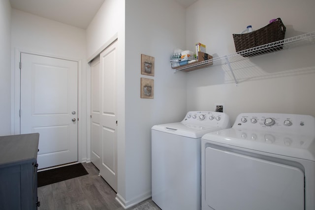 washroom featuring separate washer and dryer and dark hardwood / wood-style flooring