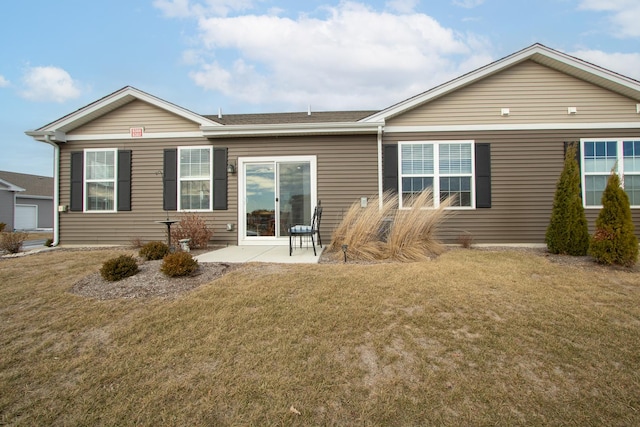 rear view of house featuring a patio and a yard