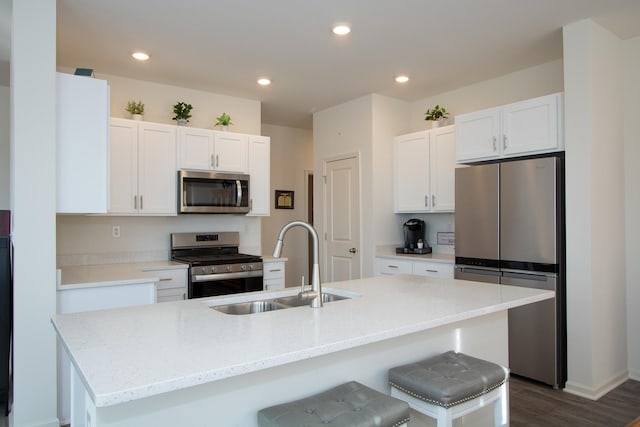 kitchen with sink, a center island with sink, and appliances with stainless steel finishes