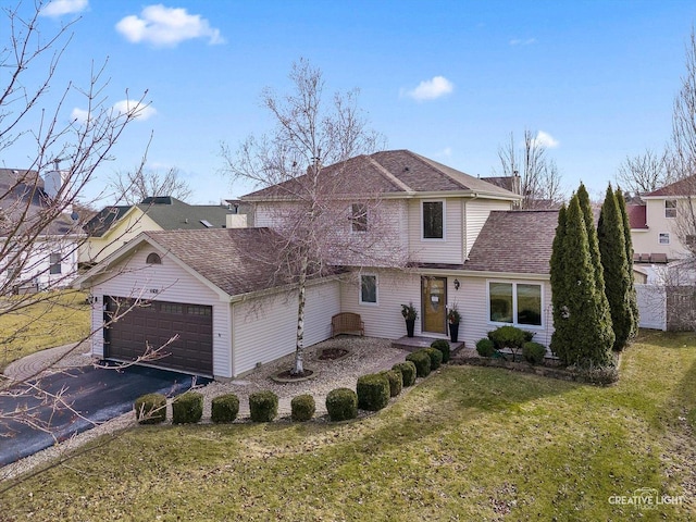 front of property with a garage and a front lawn