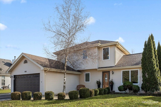 front facade featuring a garage and a front yard