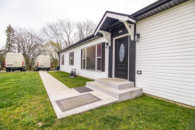 entrance to property featuring a yard