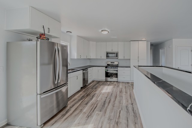 kitchen featuring white cabinetry, appliances with stainless steel finishes, and light wood-type flooring