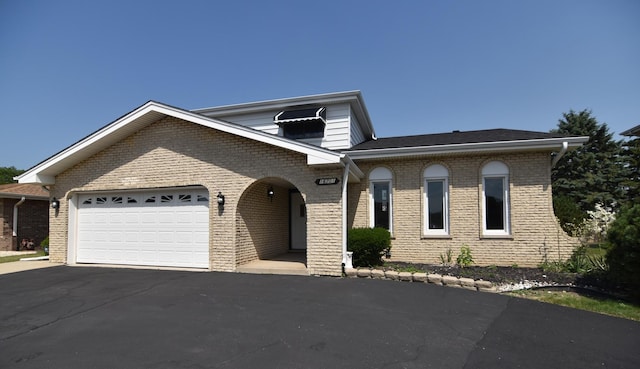 16701 Clyde Ave, South Holland, IL 60473 - view of front of property featuring asphalt driveway, a garage, and brick siding
