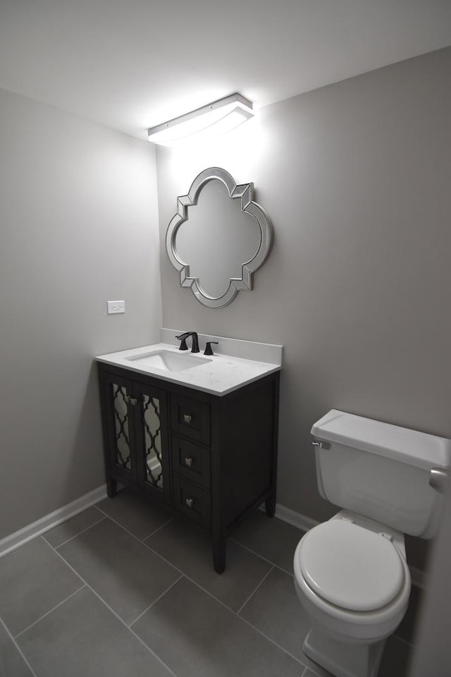 bathroom featuring tile patterned flooring, vanity, and baseboards