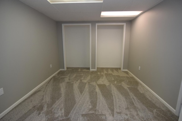 unfurnished room with carpet floors and baseboards