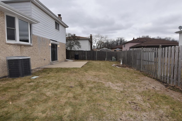 view of yard featuring a fenced backyard, central AC unit, and a patio