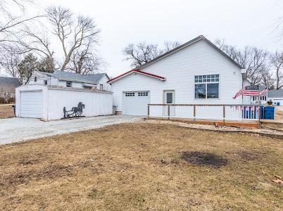 rear view of property featuring a yard