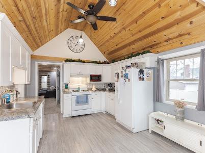 kitchen with sink, wood ceiling, white appliances, light hardwood / wood-style flooring, and white cabinets