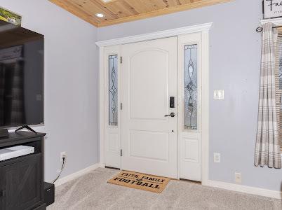 carpeted foyer featuring wooden ceiling