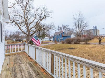 wooden deck featuring a lawn