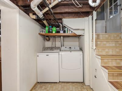 clothes washing area with washing machine and clothes dryer