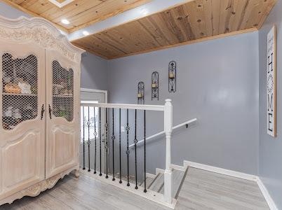 stairway with hardwood / wood-style flooring and wooden ceiling