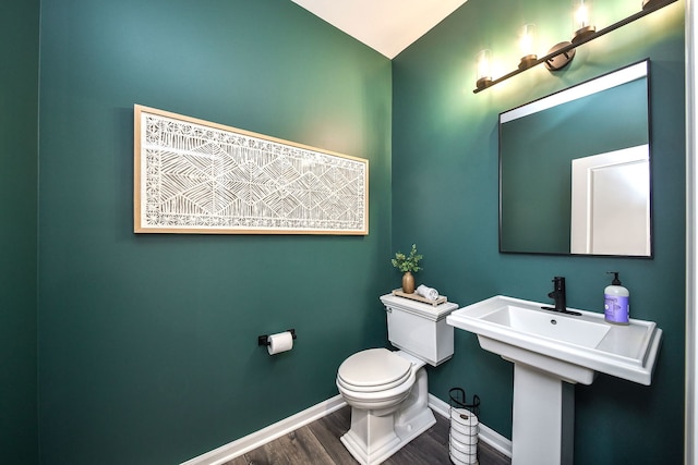 bathroom featuring wood-type flooring and toilet