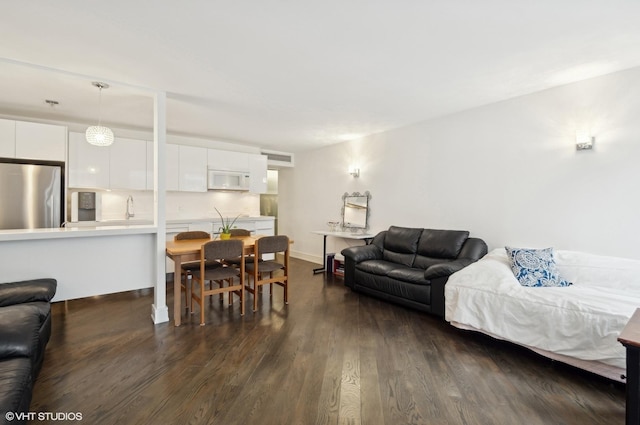 living room featuring dark hardwood / wood-style floors and sink