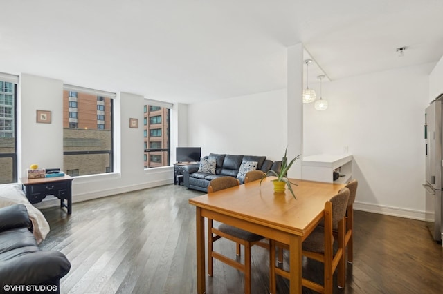 dining space featuring a healthy amount of sunlight and wood-type flooring