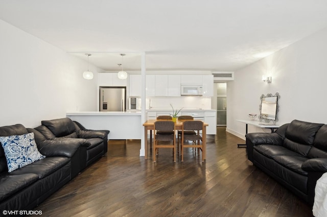 living room with dark hardwood / wood-style flooring