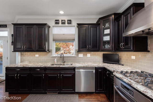 kitchen featuring sink, stainless steel dishwasher, light stone counters, crown molding, and wall chimney exhaust hood