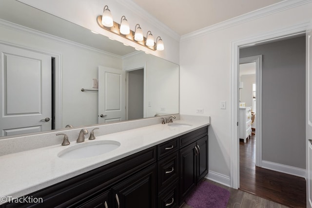 bathroom featuring hardwood / wood-style flooring, vanity, and crown molding