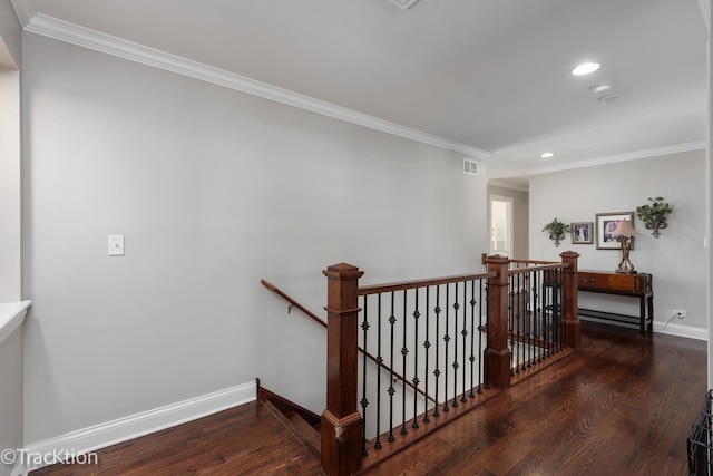 stairs featuring crown molding and hardwood / wood-style floors