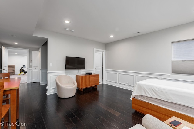 bedroom with dark hardwood / wood-style floors