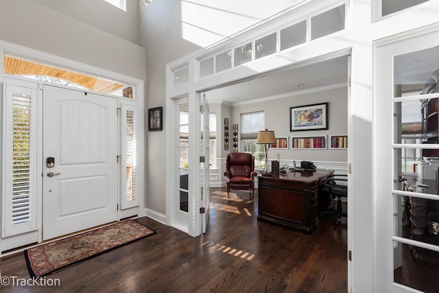 entrance foyer with french doors, dark hardwood / wood-style floors, a high ceiling, and crown molding