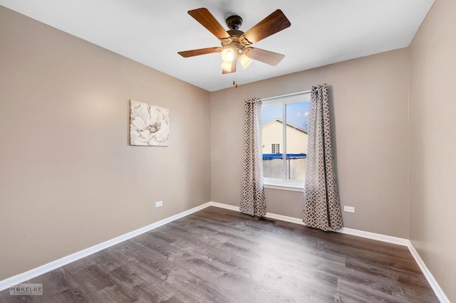 spare room featuring dark hardwood / wood-style floors and ceiling fan