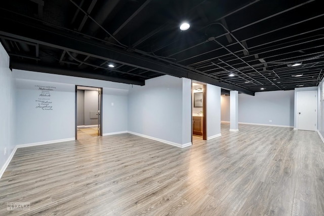 basement with hardwood / wood-style floors