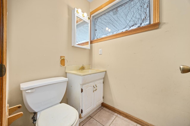 bathroom featuring vanity, tile patterned floors, and toilet