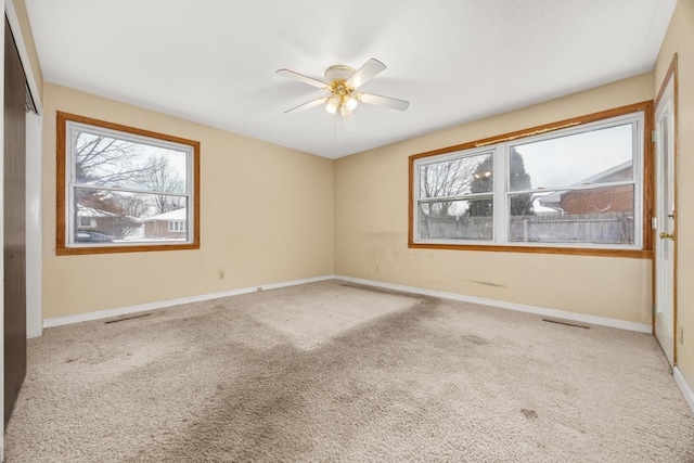 spare room with carpet and ceiling fan